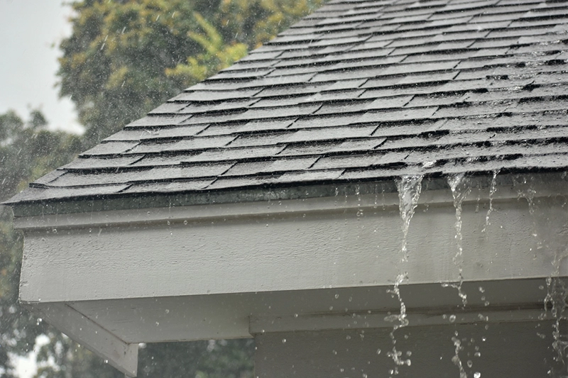 Rain falling off shingle roof in Georgetown, TX