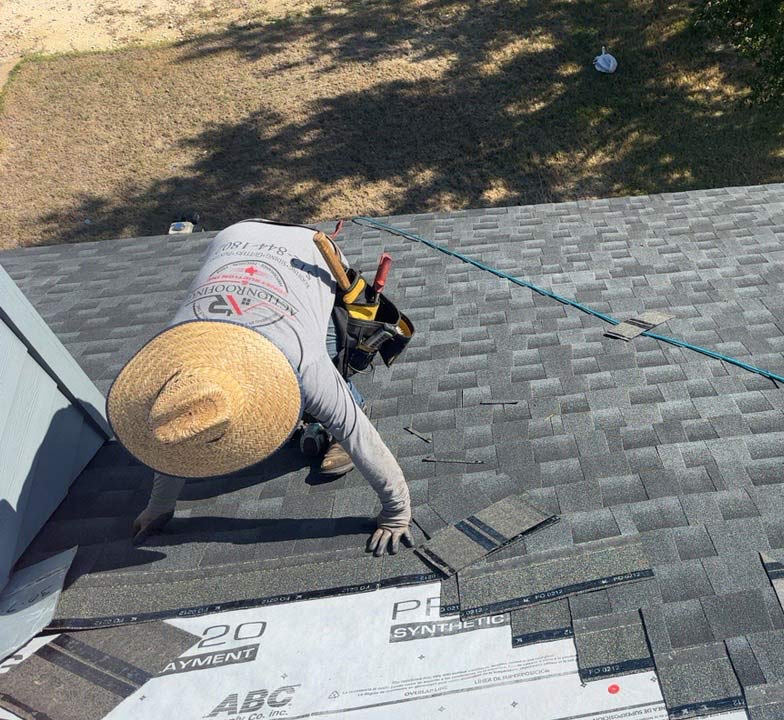 Man installing shinlge roofing on home in Dripping Springs, TX